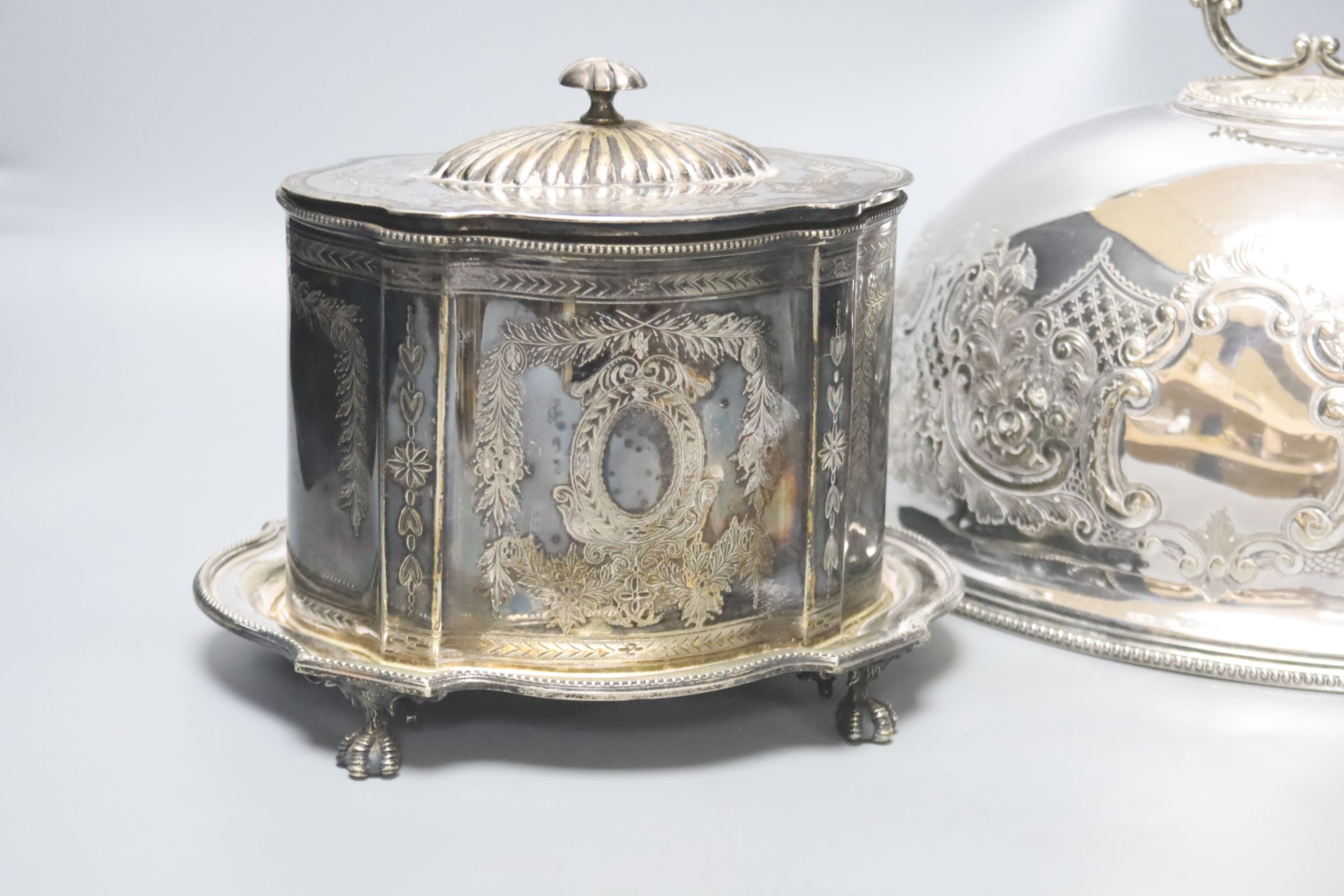 A French silver plated biscuit barrel and a meat dish cover